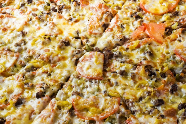 The surface texture of the pizza. Close up.