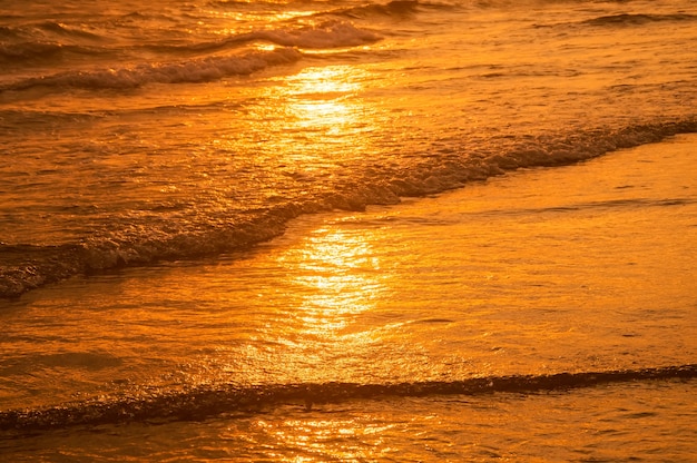 Surface of water on the beach in the sunset time