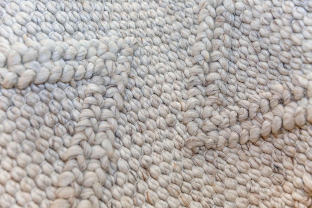 Surface of woven carpet in natural color Hobby and needlework Closeup Space for text