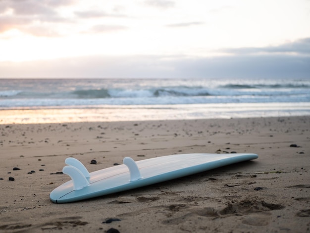 A surfboard left on the beach