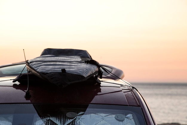 Surfboard on the roof of a van let the road trip begin