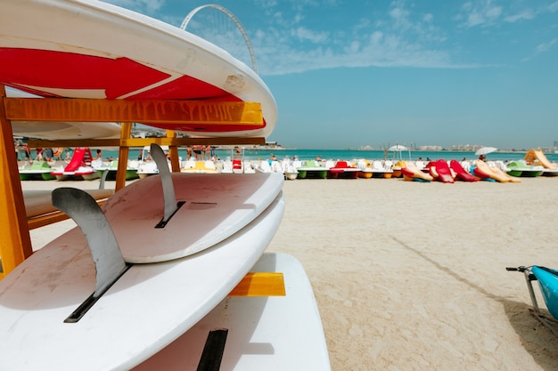 Surfboards stacked on the rack on a beach