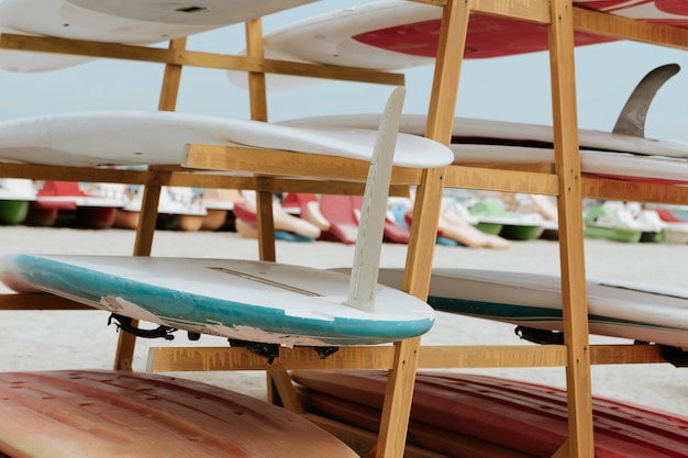 Surfboards stacked on the rack on a beach