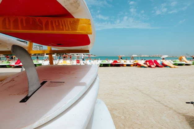 Surfboards stacked on the rack on a beach