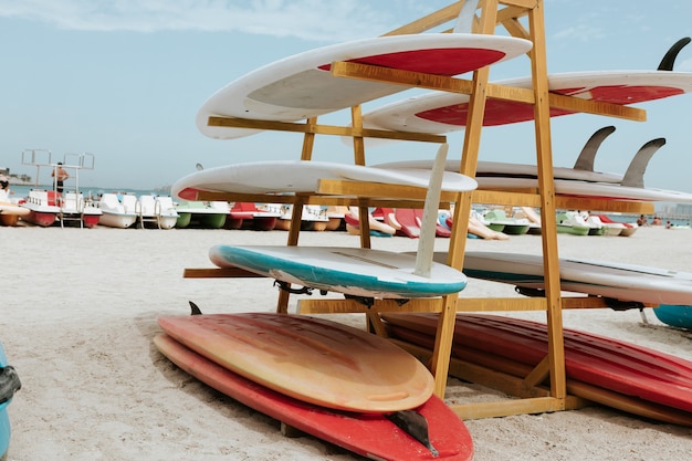 Surfboards stacked on the rack on a beach