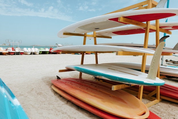 Surfboards stacked on the rack on a beach