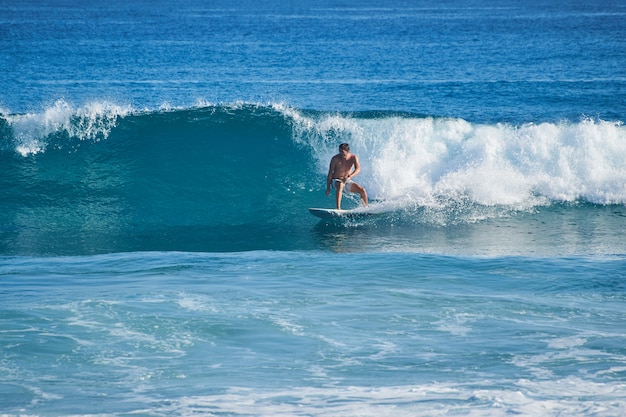 Surfer rides along a big beautiful glassy wave