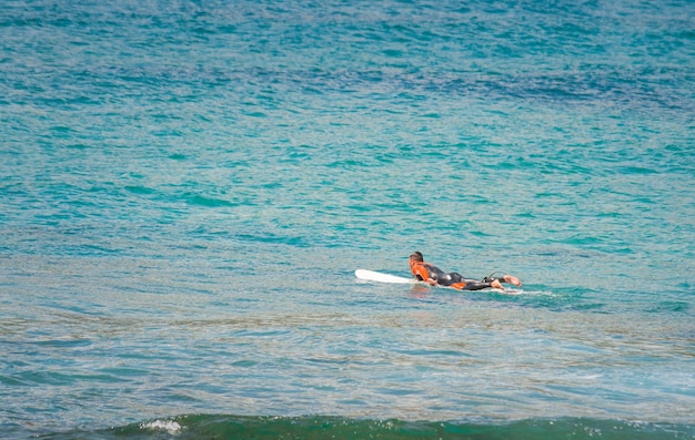 Surfer in the sea waiting for the waves