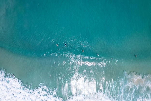 Surfers in the blue ocean top view Beautiful sea in summer season at Phuket Thailand