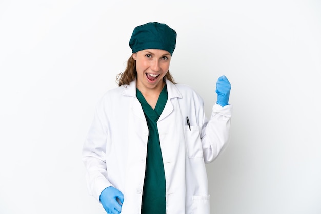 Surgeon caucasian woman in green uniform isolated on white background making guitar gesture