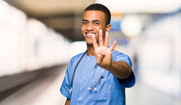 Surgeon doctor man happy and counting four with fingers in a hospital