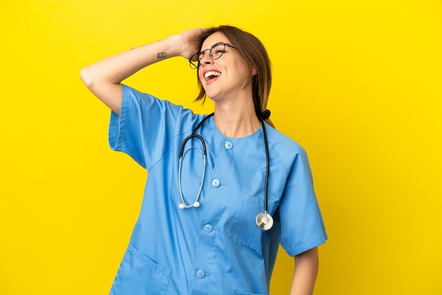 Surgeon doctor woman isolated on yellow background has realized something and intending the solution