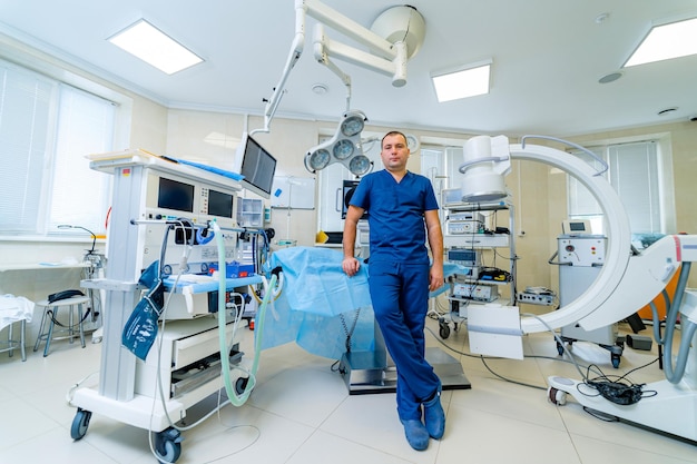 Surgeon is posing in an operating room Hospital background Male doctor at work looking at camera Medical issues