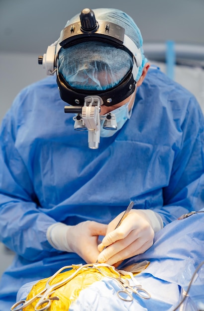 Surgeon in operation room Working with surgical instruments Modern equipment in operating room