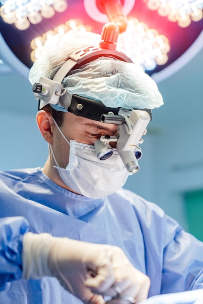 Surgeon in operation room Working with surgical instruments Modern equipment in operating room