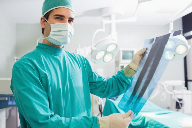 Surgeon standing while holding a X-ray