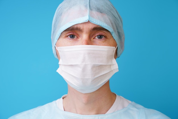 Surgeon in sterile blue uniform medical gloves and mask