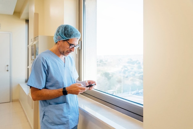 Surgeon using smartphone in operating theater