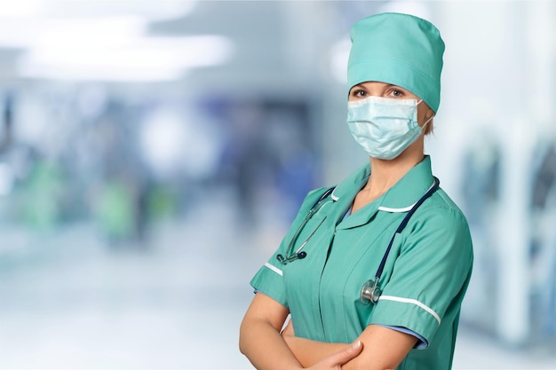 Surgeon with protective mask on background