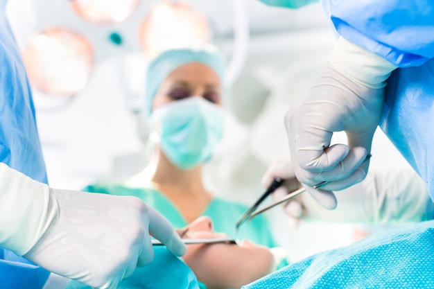 Surgeons operating in operation theater room