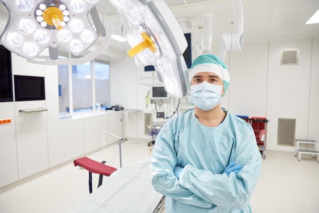 surgery, medicine and people concept - surgeon in mask operating room at hospital