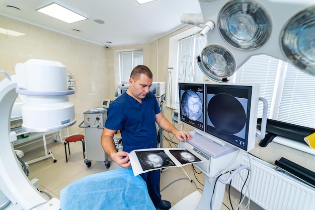 Surgery operation. Surgeon in operating room with surgery equipment and x-ray shoot. Medical background, selective focus.