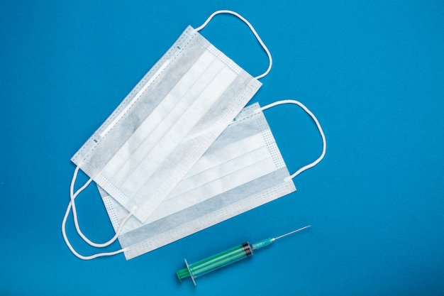 Surgical masks for coronavirus prevention and syringe