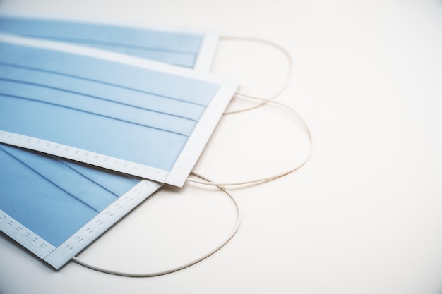 Surgical masks with rubber ear straps on white background