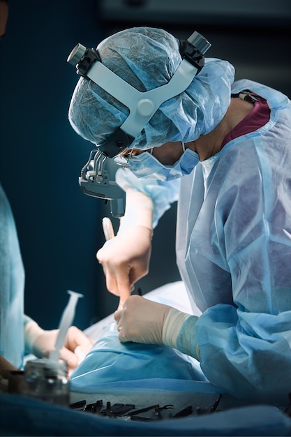 Surgical team in the operating room, closeup An international team of professional doctors in a modern operating room is undergoing surgery