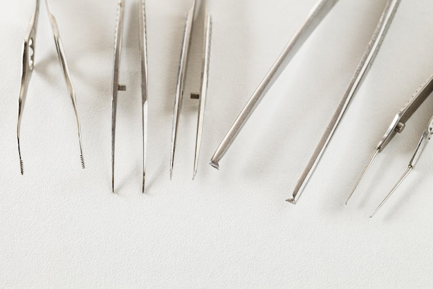 Surgical tweezers metal on white background selective focus