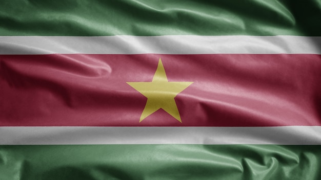 Photo surinamese flag waving in the wind. close up of suriname template blowing, soft and smooth silk.