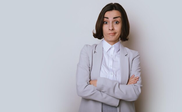 Surprised business woman isolated on gray background