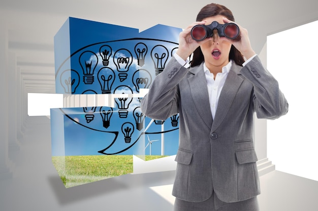 Photo surprised businesswoman looking through binoculars against digitally generated room with columns