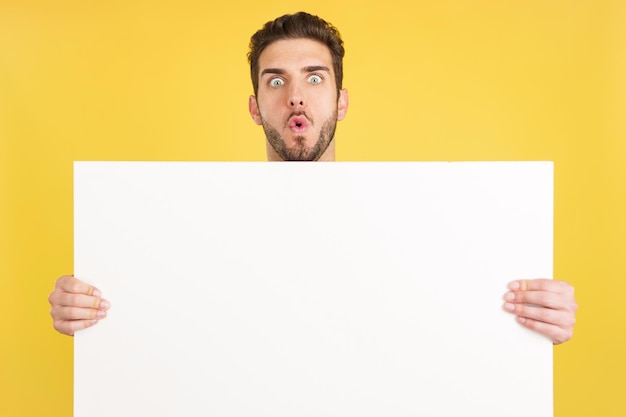 Surprised caucasian man hair holding a blank panel