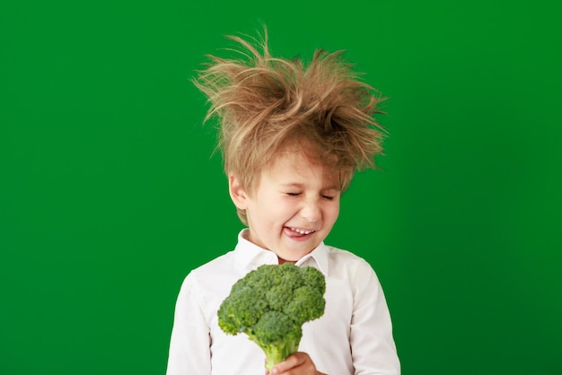 Surprised child against green chalkboard in class