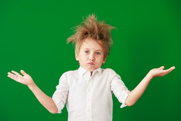 Surprised child against green chalkboard in class