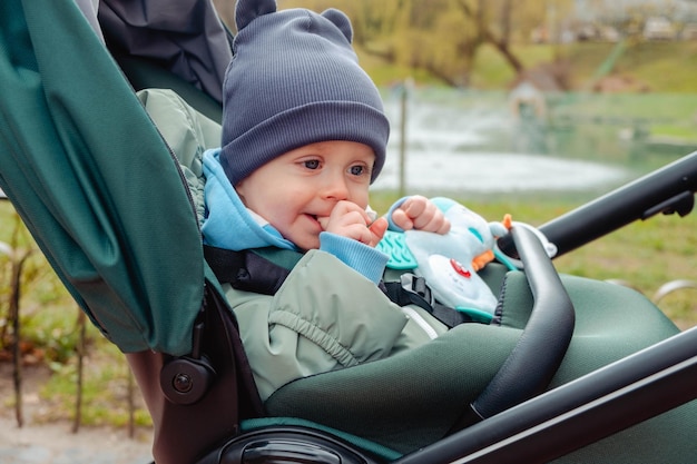 Surprised child in stroller in spring park