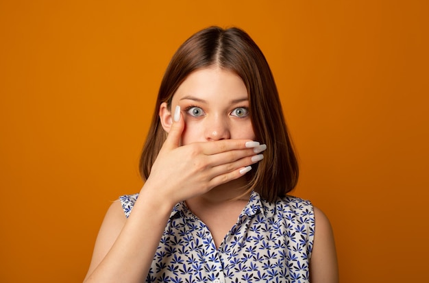 surprised face of beautiful young woman with closed mouth