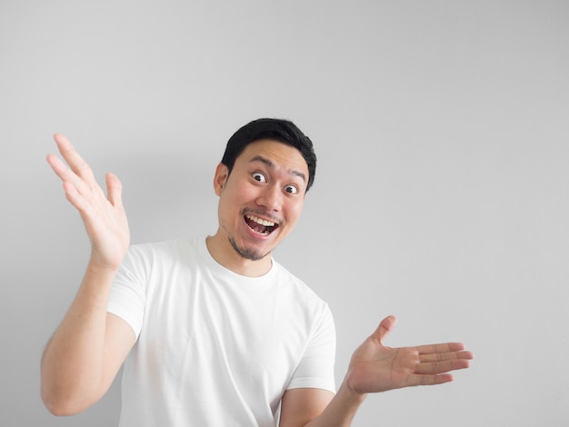 Surprised face of happy asian man in white shirt  light grey background.