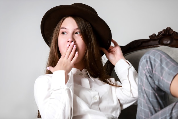 Surprised girl in a brown hat