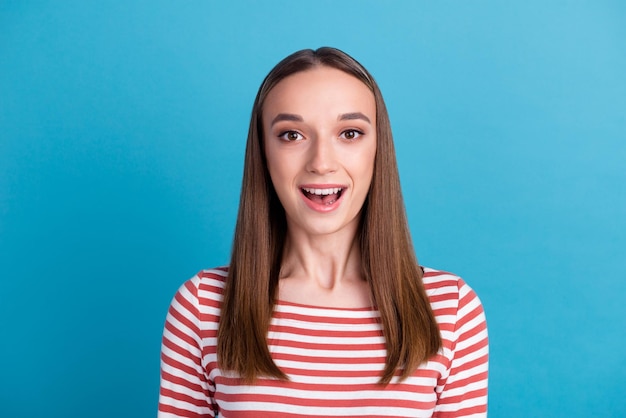 Surprised happy beautiful woman looking in camera with excitement Isolated on blue color background