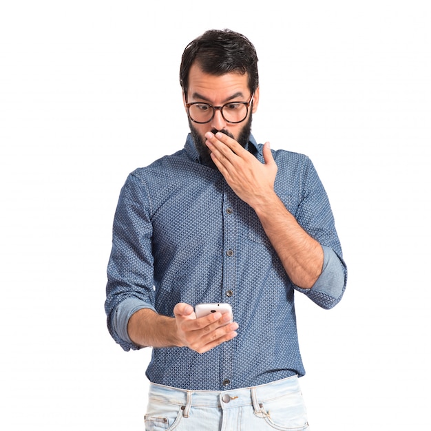 Surprised hipster man talking to mobile