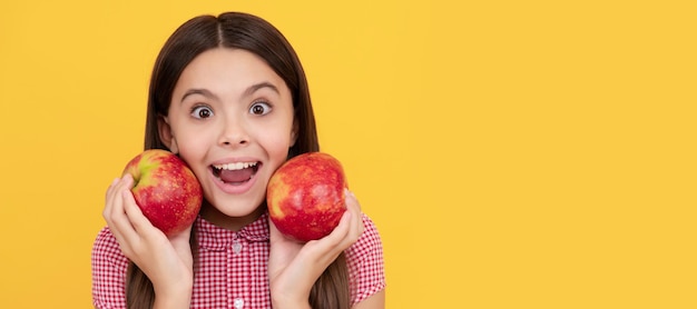 Surprised kid hold healthy apple fruit with vitamin Child girl portrait with apple horizontal poster Banner header with copy space