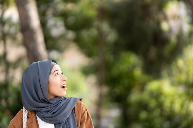 Surprised muslim woman in a urban park