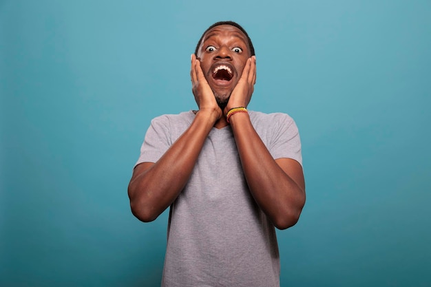 Surprised person having shocked reaction after hearing news, having mouth open and big eyes to express astonishment. Speechless man having confused expression after listening to gossip.