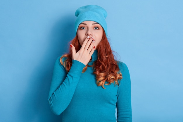 Surprised shocked astonished amazed girl covering mouth with hand with beautiful manicure