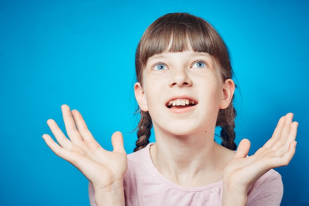 Surprised shocked astonished amazed girl looking up above her head