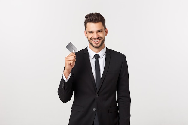 Surprised, speechless and impressed handsome caucasian businessman in classic suit showing credit card, say wow, standing   astonished