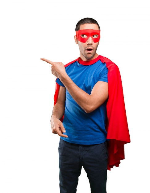 Surprised superhero pointing