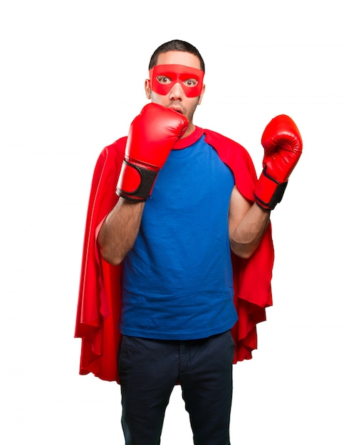 Surprised superhero with a boxing gloves